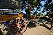 Inwa, Myanmar - tourists ride on a horse-drawn carriage. Riding on a horse cart is the easiest way to get around Inwa's narrow and dusty road to explore scatterred attractions.